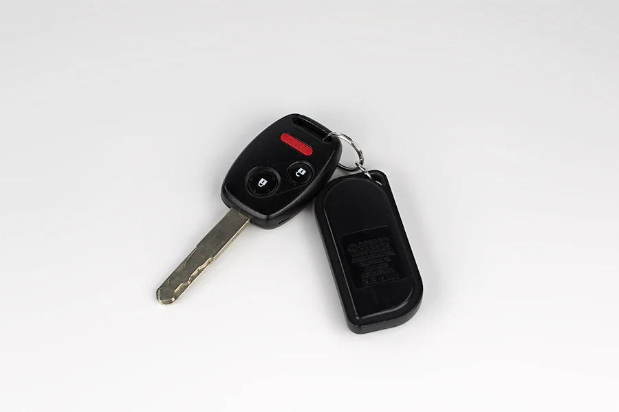 A car key and remote on a white surface.